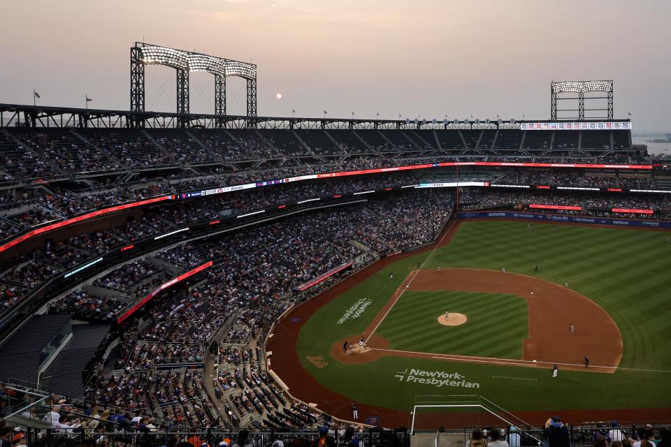 General view of Citi Field during the third inning between the New York Mets and the San Francisco Giants as the sun sets behind haze on June 30, 2023, from Canadian wildfires.