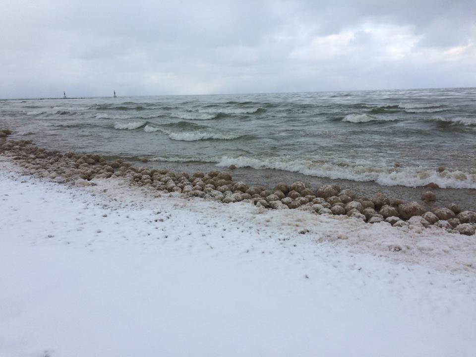 Ice balls, a rare phenomenon on Lake Michigan, rolled up on the beaches Friday at Holland State Park.