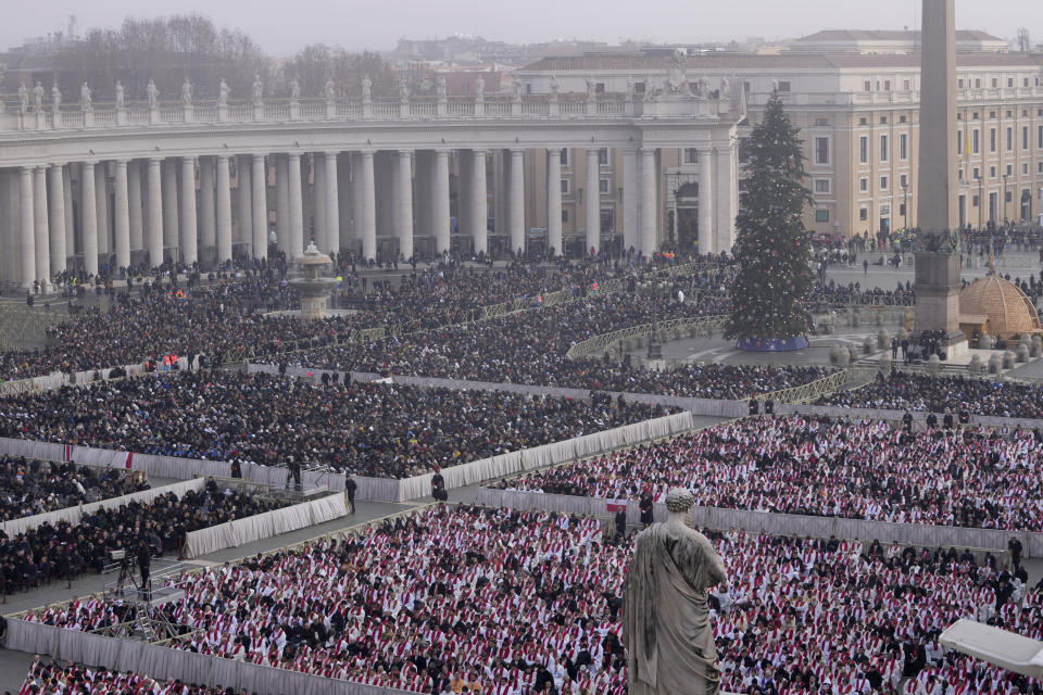 Faithful attend the funeral mass for late Pope Emeritus Benedict XVI in St. Peter's Square at the Vatican, Thursday, Jan. 5, 2023. Benedict died at 95 on Dec. 31 in the monastery on the Vatican grounds where he had spent nearly all of his decade in retirement. (AP Photo/Ben Curtis)