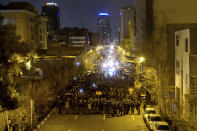 In this photograph taken Saturday, Jan. 11, 2020, Iranian police officers take position while protesters gather in front of Amir Kabir University in Tehran, Iran, to remember victims of a Ukrainian airplane shot down by an Iranian missile. On Monday, Jan. 13, 2020, online videos purported to show that Iranian security forces fired both live ammunition and tear gas to disperse demonstrators protesting against the Islamic Republic's initial denial that it shot down a Ukrainian jetliner. (AP Photo)