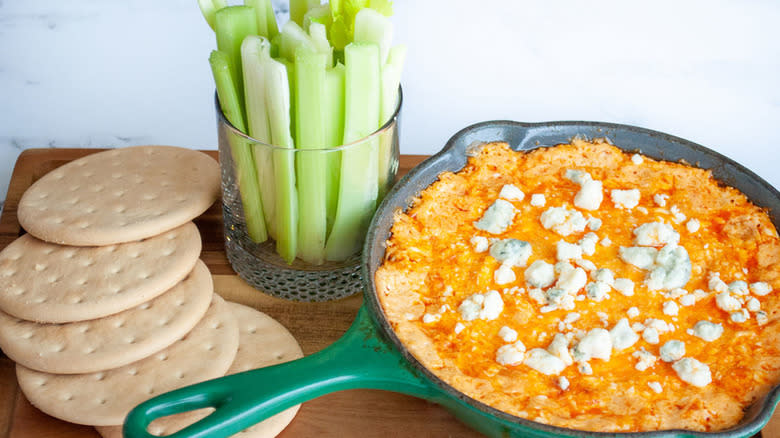 creamy dip with crackers and celery