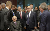FILE - German Finance Minister Wolfgang Schaeuble, center left, speaks with Finland's Finance Minister Alexander Stubb, third left, and French Finance Minister Michel Sapin, center right, during a meeting of eurogroup finance ministers in Brussels on Saturday, June 27, 2015. Wolfgang Schaeuble, who helped negotiate German reunification in 1990 and as finance minister was a central figure in the austerity-heavy effort to drag Europe out of its debt crisis more than two decades later, has died on Tuesday, Dec. 26, 2023. He was 81. (AP Photo/Thierry Monasse, File)