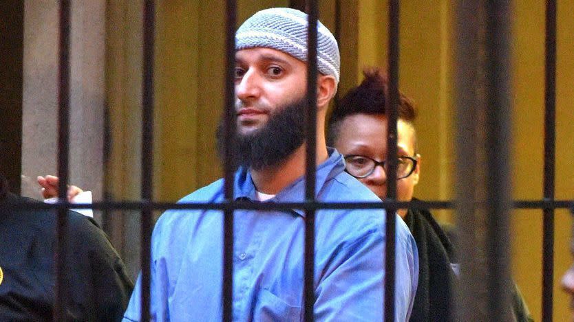 Officials escort Adnan Syed from the Baltimore Circuit Court courthouse in 2016.