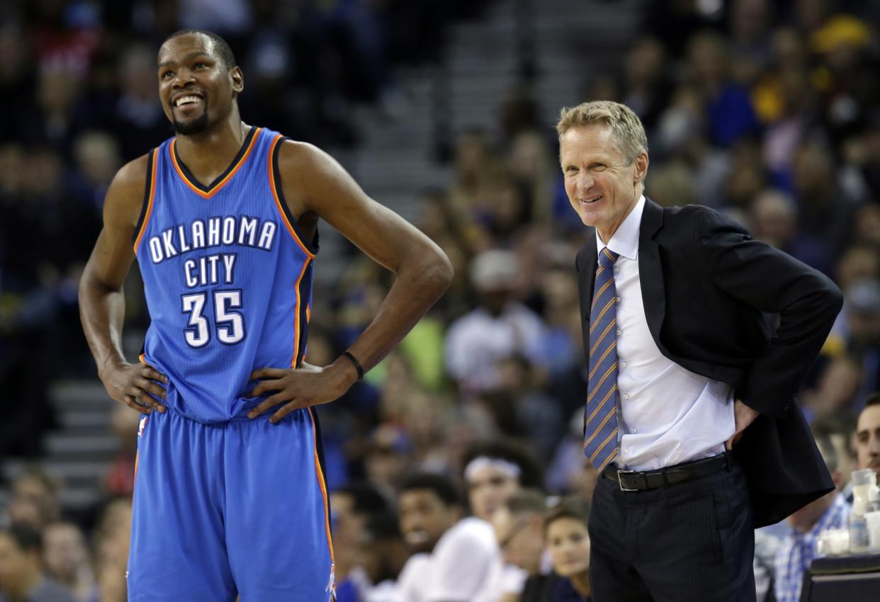 Kevin Durant, then of the Thunder, smiles next to Warriors head coach Steve Kerr during the first half of a March 3, 2016 game. (AP/Marcio Jose Sanchez)