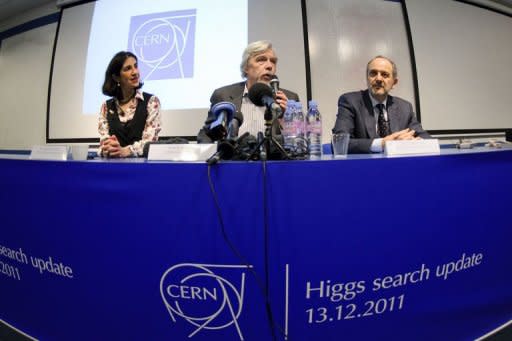 L to R: Spokesperson for the Atlas experimence Fabiola Gianotti, director general of the European Organization for Nuclear Research (CERN), Rolf-Dieter Heuer and Spokesperson for the CMS experience Guido Tonelli attend a press conference at the CERN in Geneva. Physicists said that they had narrowed the search for the elusive sub-atomic Higgs Boson particle