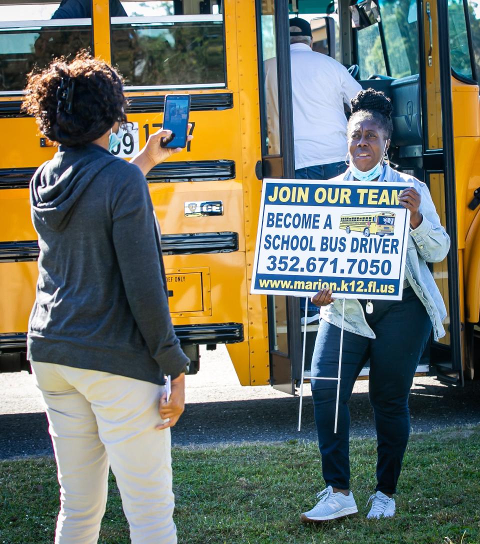 Marion County Public Schools' bus drivers Terri Haynes, left, and Glenda Walker, right, do a Facebook Live video bus driver hiring event in December 2021.