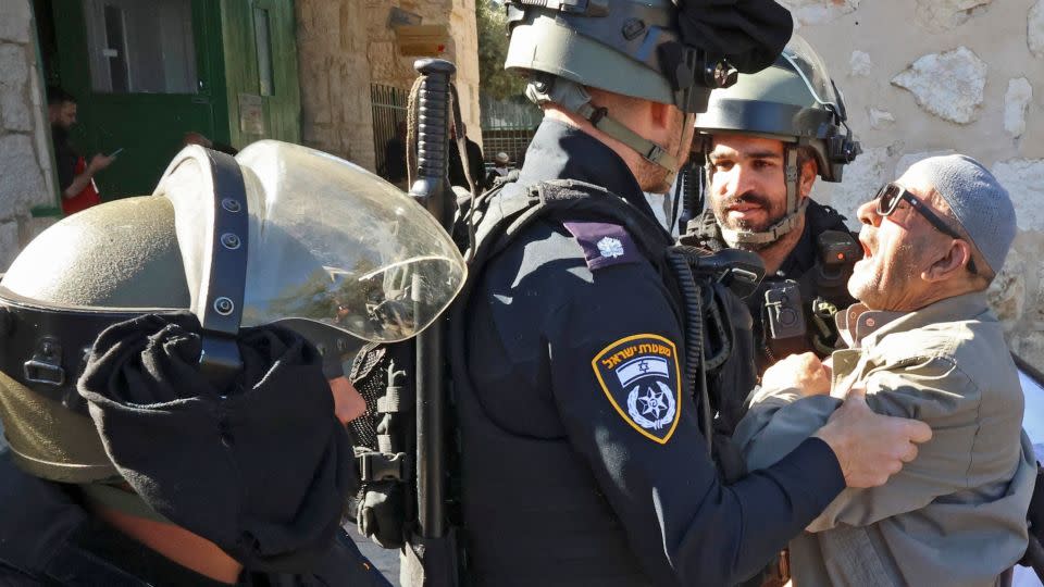 Israeli security forces scuffle with a Palestinian man as he tries to enter the al-Aqsa mosque compound to attend  Friday prayers on April 15, 2022. - HAZEM BADER/AFP/Getty Images