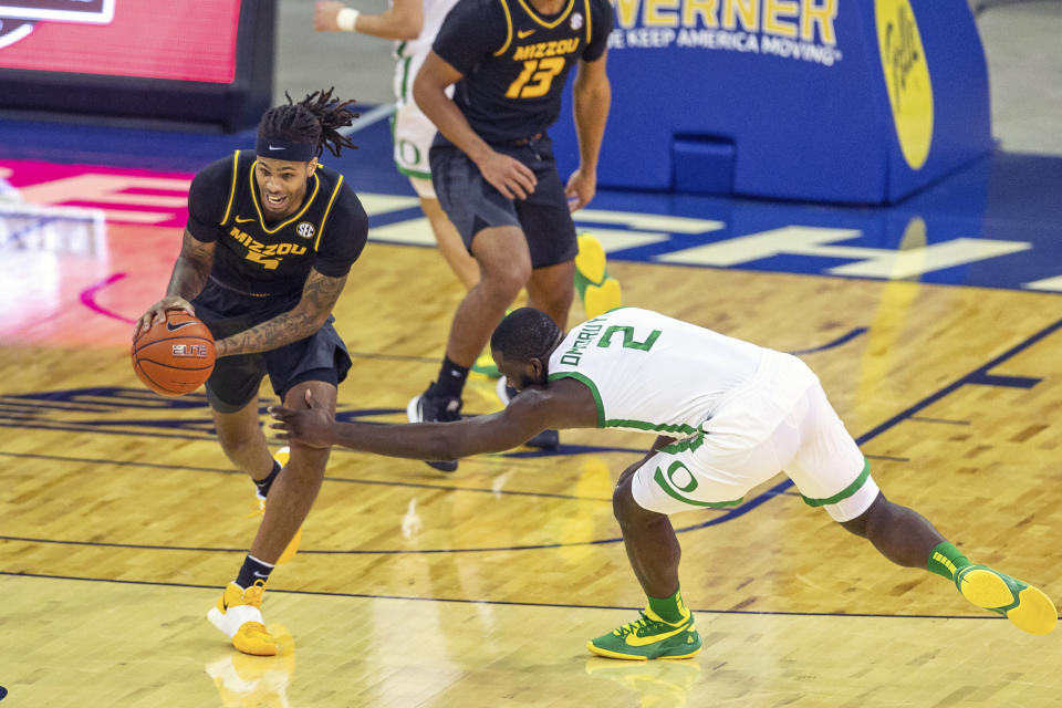 Missouri forward Mitchell Smith (5) steals the ball from Oregon forward Eugene Omoruyi (2) during the first half of an NCAA college basketball game, Wednesday, Dec. 2, 2020 in Omaha, Neb. (AP Photo/John Peterson)