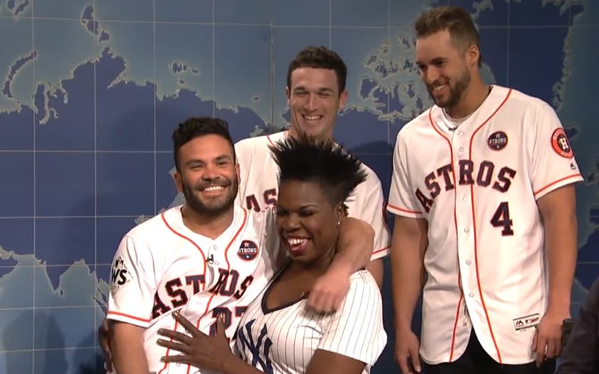 Houston Astros second baseman Jose Altuve sits on comedian Leslie Jones’ lap on Saturday Night Live, and they both seem to be enjoying it a lot. (NBC screen shot)