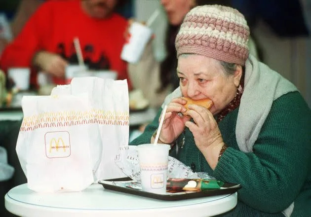 A Russian woman eats a hamburger at the first McDonald's in the Soviet Union on Jan. 31, 1990. (Photo: via Associated Press)