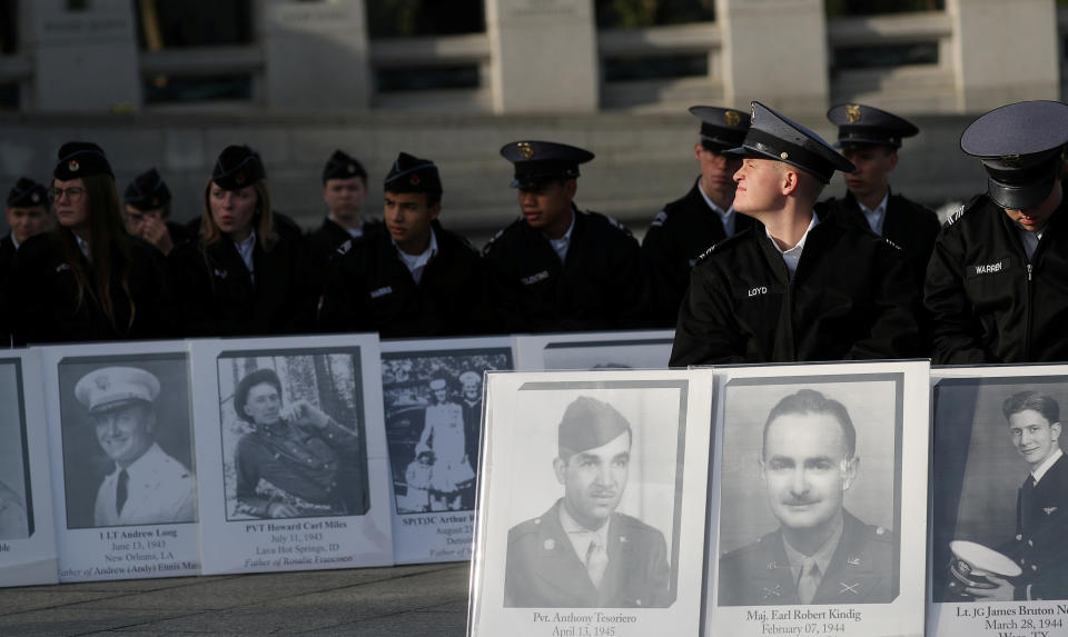 Cadets hold portraits of loved ones who died during World War II at a Veterans Day Observance to honor "the 16 million men and women who served in World War II"  in Washington, Nov. 11, 2019. (Photo: Siphiwe Sibeko/Reuters)