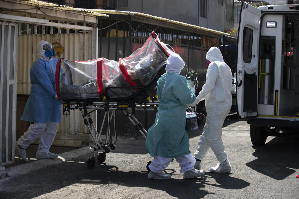 Paramedics in hazmat suits move a COVID-19 patient inside a biocontainment unit from his home to a hospital in the Iztapalapa district of Mexico City, Tuesday, Feb. 2 2021. (AP Photo/Marco Ugarte)