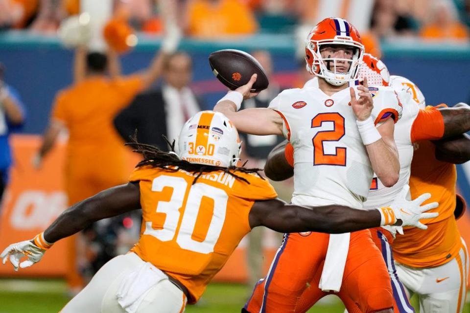 Clemson quarterback Cade Klubnik (2) throws a pass as Tennessee defensive lineman Roman Harrison (30) closes in during the first half of the Orange Bowl NCAA college football game Friday, Dec. 30, 2022, in Miami Gardens, Fla. (AP Photo/Rebecca Blackwell)