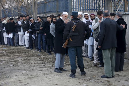 Afghan men queue up to apply for passports at a passport department office in Kabul, Afghanistan, November 29, 2015. Picture taken November 29, 2015. To match AFGHANISTAN-BRAINDRAIN/ REUTERS/Omar Sobhani