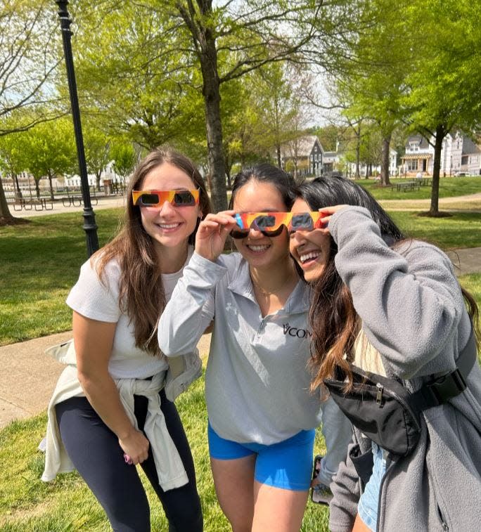 Malorie Reuter, Jenny Park and Naina Kohli view the partial solar eclipse at Barnet Park in Spartanburg on Monday, April 8, 2024.