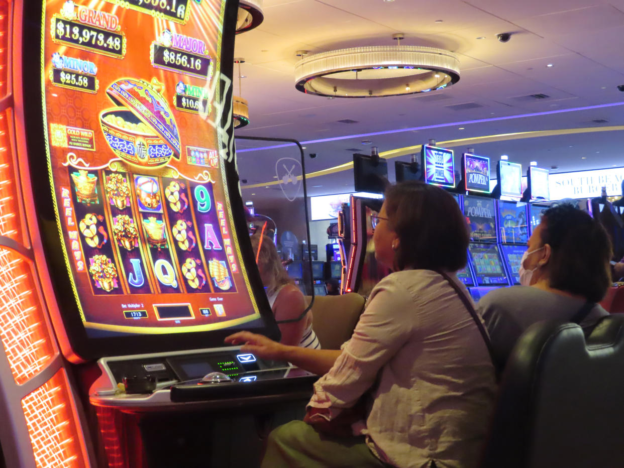 Gamblers play slot machines at the Hard Rock Casino in Atlantic City, N.J., on Aug. 8, 2022. Figures released on Nov. 9, 2022, by the American Gaming Association show the U.S. commercial casino industry had its best quarter ever, winning over $15 billion from gamblers in the third quarter of this year. (AP Photo/Wayne Parry)