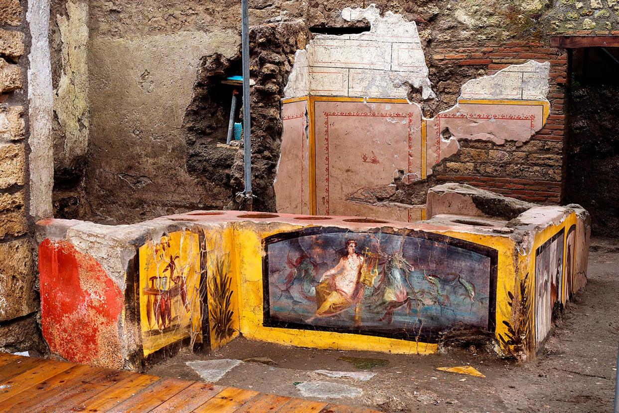 This picture released on December 26, 2020 by the Pompei Press Office shows a thermopolium, a sort of street "fast-food" counter in ancient Rome, that has been unearthed in Pompei, decorated with polychrome motifs and in an exceptional state of preservation