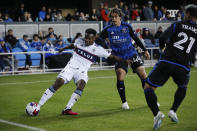 Vancouver Whitecaps defender Javain Brown works with the ball near San Jose Earthquakes forward Cade Cowell (44) during the first half of an MLS soccer match in San Jose, Calif., Saturday, March 4, 2023. (AP Photo/Josie Lepe)