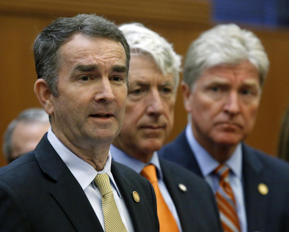 Virginia Gov. Ralph Northam, left, makes remarks at a press conference dealing with gun violence while Attorney General Mark Herring, center and Secretary of Public Safety and Homeland Security Brian Moran, right, look on inside the Patrick Henry Building in Richmond, VA Tuesday, June 4, 2019. The governor issued an executive order calling for a special session of the legislature later this month to deal with the situation. (Bob Brown/Richmond Times-Dispatch via AP)