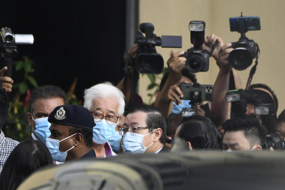 Malaysian former Finance Minister and Penang Chief Minister Lim Guan Eng, center, arrives at courthouse in Butterworth, Malaysia, Monday, Aug. 10, 2020. Lim pleaded not guilty to a second graft charge relating to a $1.5 billion undersea tunnel project. Lim has slammed the charges as political persecution by the new government. (AP Photo/David ST Loh)