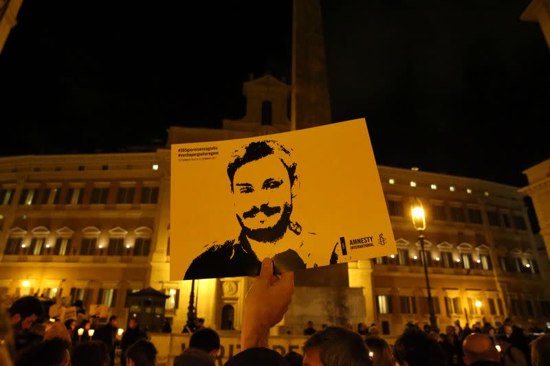 FILE PHOTO: A man holds a placard during a vigil to commemorate Giulio Regeni, who was found murdered in Cairo a year ago, in downtown Rome