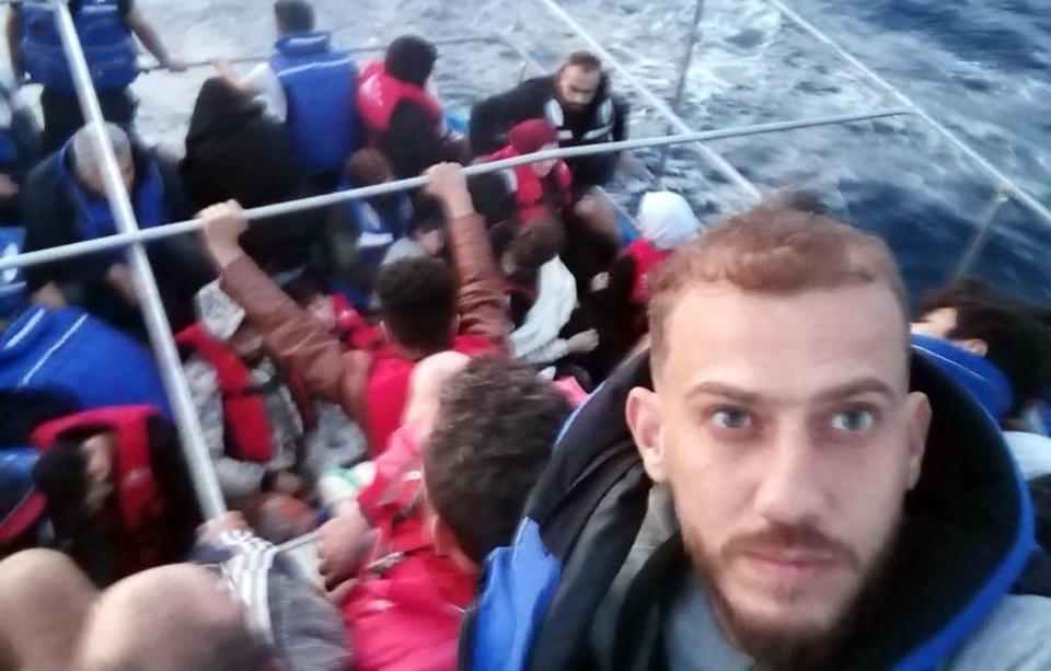 Jihad Michlawi, right, takes a selfie on board an overcrowded migrant boat carrying about 150 Lebanese, Syrians, and Palestinians in the Mediterranean Sea, Lebanon, early morning Wednesday, Sept. 21, 2022. Michlawi is one of dozens of survivors from a migrant boat that left Tripoli, that capsized near the Syrian coastal city of Tartus. (Courtesy of Jihad Michlawi via AP)