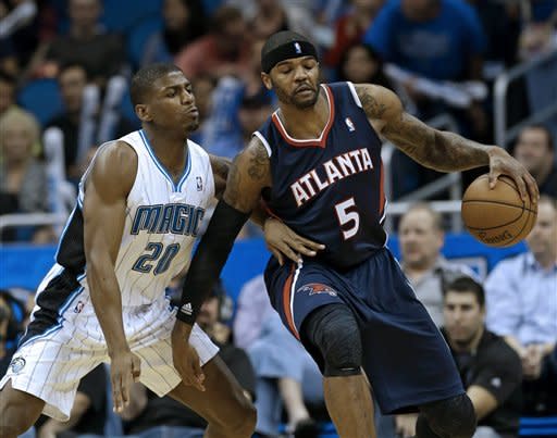 Atlanta Hawks' Josh Smith (5) make a move to get around Orlando Magic's DeQuan Jones (20) during the second half of an NBA basketball game, Wednesday, Feb. 13, 2013, in Orlando, Fla. Atlanta won 108-76.(AP Photo/John Raoux)