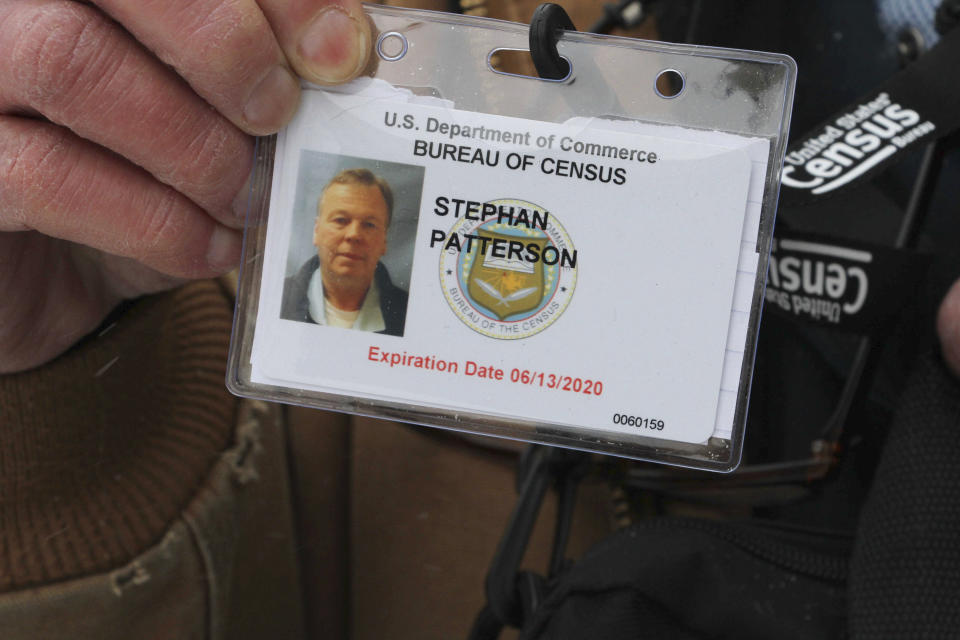 In this Friday, Feb. 21, 2020 photo, Stephan Patterson holds his U.S. Census ID badge in Anchorage, Alaska. Patterson and other U.S. Census takers are reporting problems when conducting first-in-the-nation counts in rural parts of Alaska, including lack of communication about assignments, frustration with a smartphone app for filing time sheets and disappointment when they find out they are not being reimbursed for purchasing cold-weather gear. (AP Photo/Mark Thiessen)