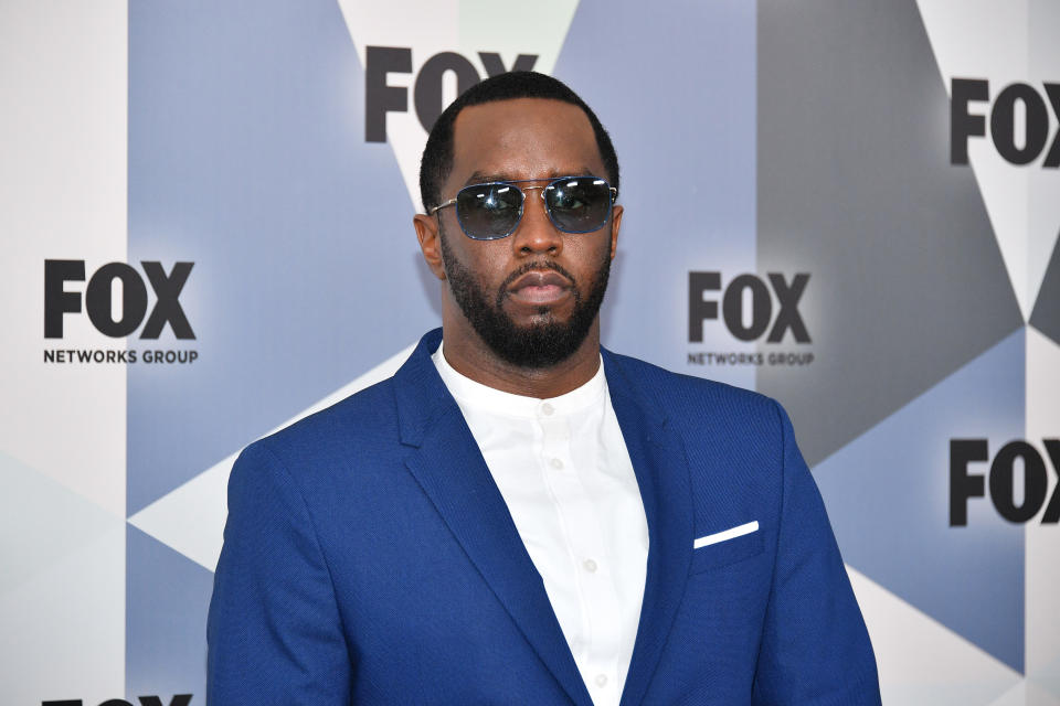 Sean "Diddy" Combs Wearing Blue Suit And White Shirt 
