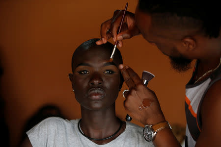A Kenyan model Ajuma Nasanyana goes through a make up behind the scenes of a fashion show featuring African fashion and culture, during a gala marking the launch of a book called "African Twilight: The Vanishing Rituals and Ceremonies of the African Continent" at the African Heritage House in Nairobi, Kenya March 3, 2019. REUTERS/Baz Ratner