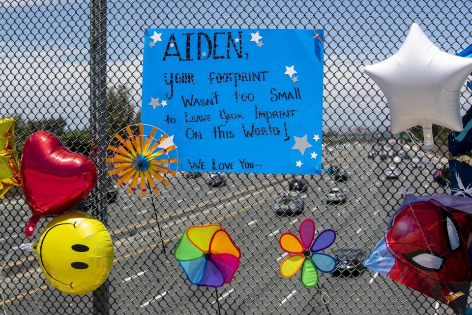 Shown are some of the balloons, pinwheels and messages placed at the memorial to Aiden Leos in Orange.
