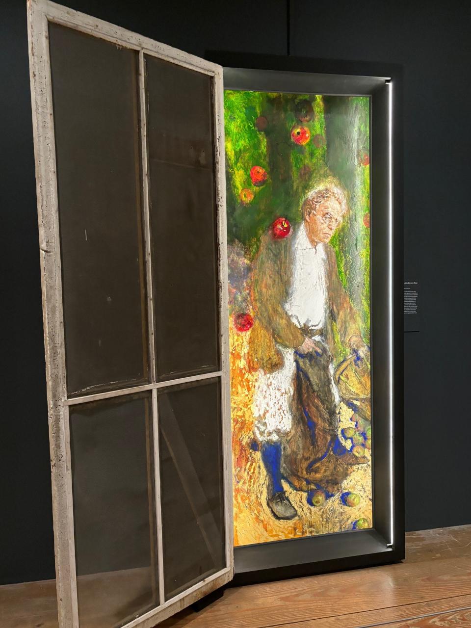 "Apples: Fifth in the Screen Door Sequence, 2021" by Jamie Wyeth shows his grandfather N.C. Wyeth gathering apples in an eternal autumn. It's included in the exhibition "Jamie Wyeth: Unsettled" that opened March 17, 2024, at the Brandywine Museum.