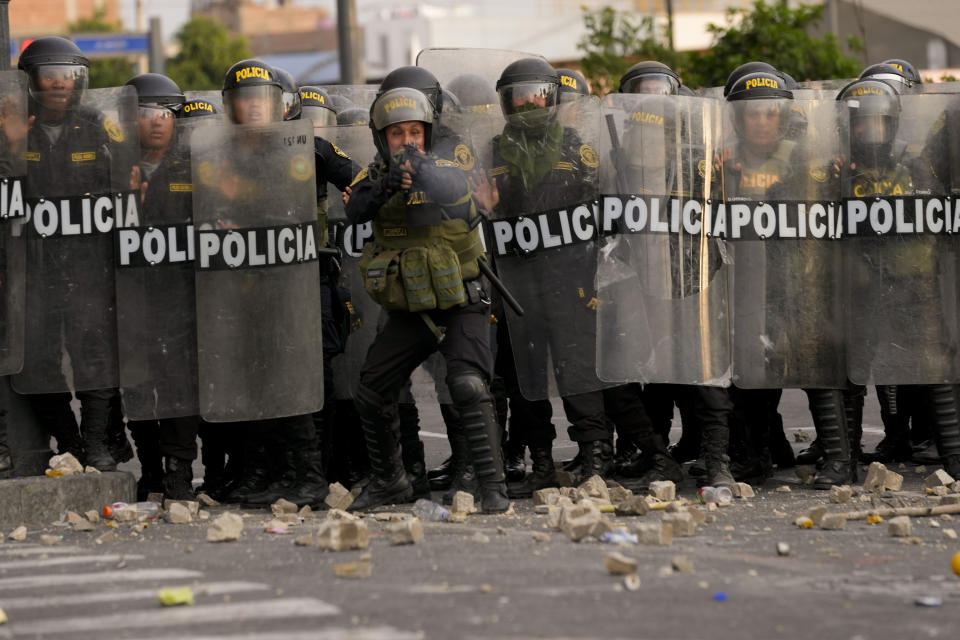 Police face off anti-government protesters in Lima, Peru, Thursday, Jan. 19, 2023. Protesters are seeking immediate elections, the resignation of President Dina Boluarte, the release from prison of ousted President Pedro Castillo and justice for protesters killed in clashes with police. (AP Photo/Martin Mejia)