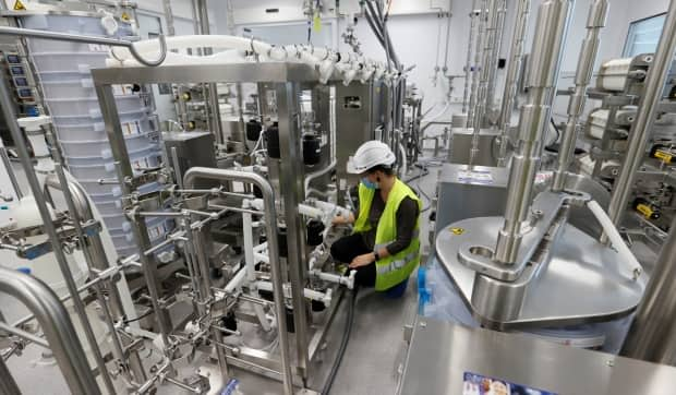 A staff member sets up an antibody production line at the Ibex building of Lonza, where the Moderna mRNA (COVID-19 vaccine is produced, in Visp, Switzerland, on Sept. 29, 2020. (Denis Balibouse/Reuters - image credit)