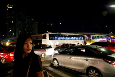 Janice Sarad, 22, who works for a bank, looks at traffic congestion along EDSA road, in Makati City, Philippines, December 3, 2018. REUTERS/Eloisa Lopez