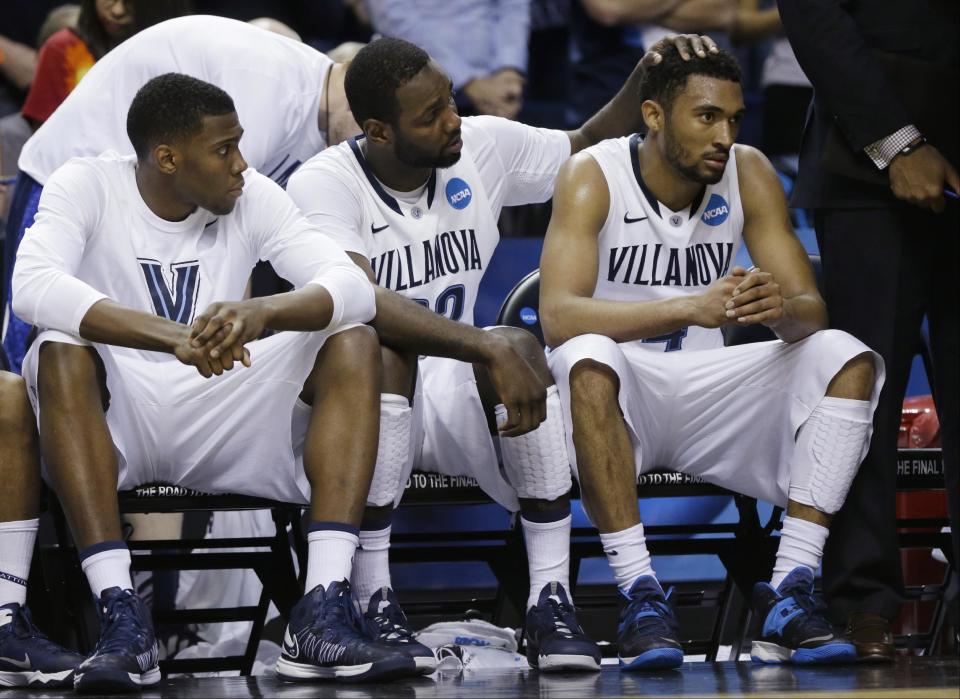 Villanova's JayVaughn Pinkston (22) and Darrun Hilliard II (4) react with teammates during the second half of a third-round game in the NCAA men's college basketball tournament in Buffalo, N.Y., Sunday, March 23, 2014. (AP Photo/Frank Franklin II)