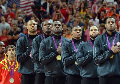 US players listen to their national anthem on the podium after winning the gold medal in the London 2012 Olympic Games men's basketball competition at the North Greenwich Arena in London. The US won the gold medal followed by the silver to Spain and the bronze to Russia