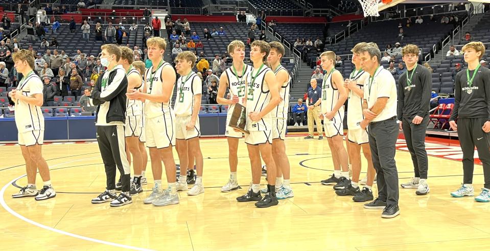 McNicholas players with their runner-up awards after losing to Alter during the OHSAA Division II boys district championship games March 9, 2024 at University of Dayton Arena.