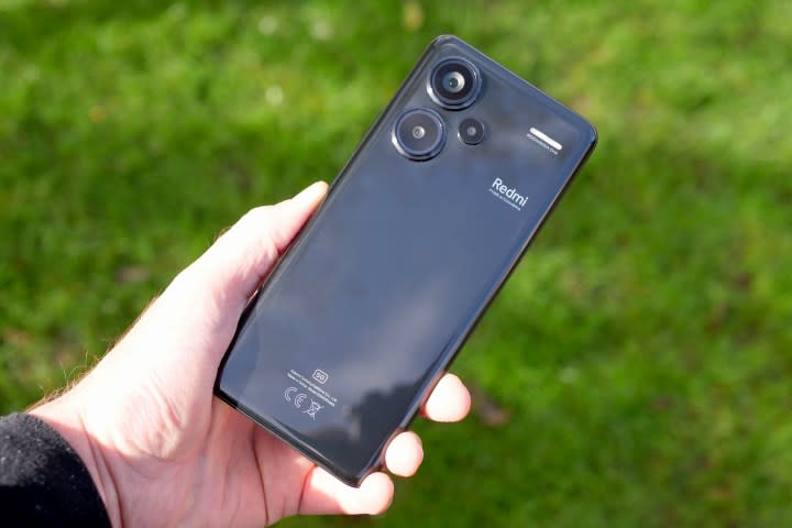 A person holding the Redmi Note 13 Pro Plus.