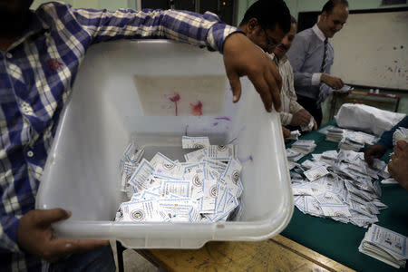 A man carries a ballot box as electoral workers sort ballots to count votes during the presidential election in Cairo, Egypt, March 28, 2018. REUTERS/Ammar Awad