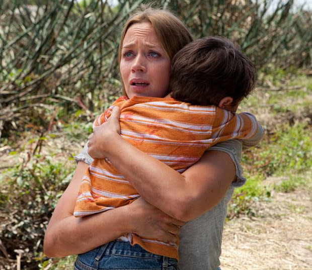 Emily Blunt hugging her child in Looper