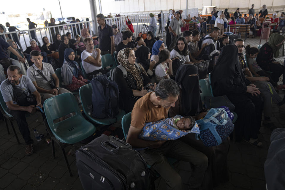 Palestinians wait to cross into Egypt at Rafah, Gaza Strip, on Wednesday, Nov. 1, 2023. (AP Photo/Fatima Shbair)