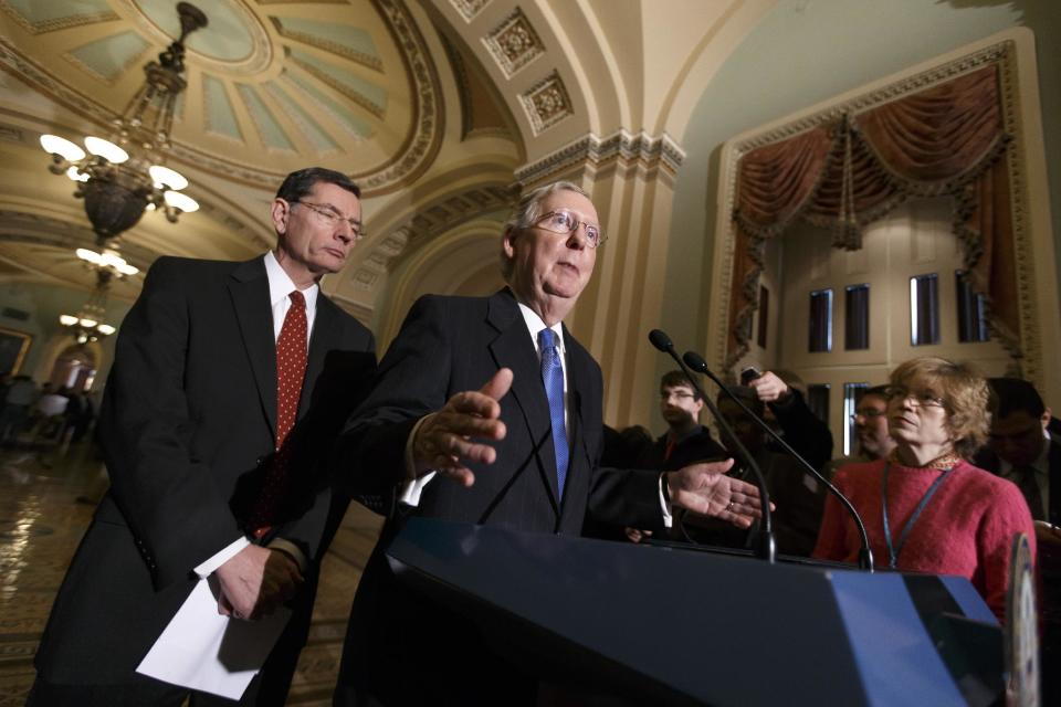 In this Jan. 7, 2014, photo, Senate Minority Leader Mitch McConnell, R-Ky., joined by Sen. John Barrasso, R-Wyo., left, the Republican Policy Committee chairman, tells reporters that Senate Majority Leader Harry Reid, D-Nev., and his political tactics are almost entirely responsible for making the Senate dysfunctional, following a procedural vote on legislation to renew jobless benefits for the long-term unemployed, at the Capitol. The struggle in Washington over whether or not to renew expired jobless benefits for the long-term unemployed is as much about providing aid to 1.3 million out-of-work Americans as it is about drawing the first political bright line of an election year that has the economy as one of its central themes. (AP Photo/J. Scott Applewhite)