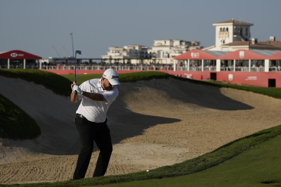 Shane Lowry of Ireland plays a bunker on the 18th hole during the third round of Abu Dhabi HSBC Golf Championship, in Abu Dhabi, United Arab Emirates, Saturday, Jan. 21, 2023. (AP Photo/Kamran Jebreili)