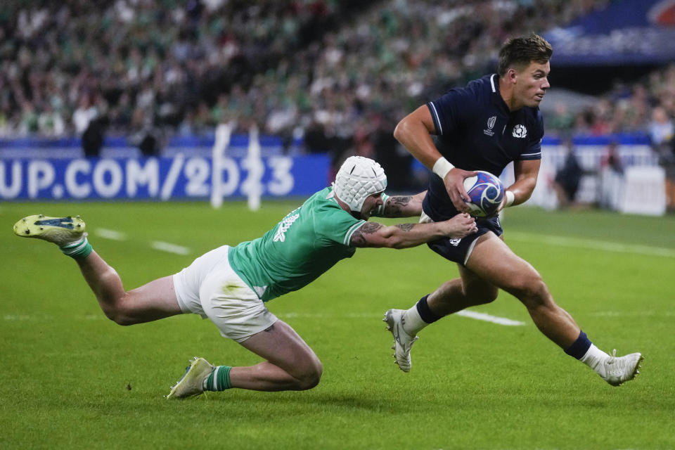 Scotland's Huw Jones, right, and Ireland's Mack Hansen challenge for the ball during the Rugby World Cup Pool B match between Ireland and Scotland at the Stade de France in Saint-Denis outside of Paris, Saturday, Oct. 7, 2023. (AP Photo/Thibault Camus)