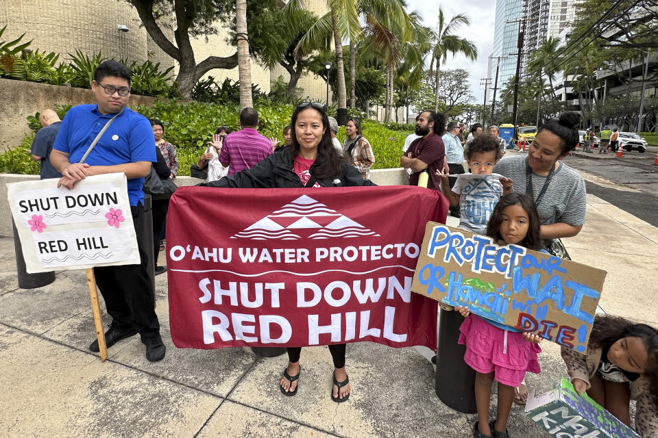 Activists protest before a trial for a mass environmental injury case outside the federal courthouse on Monday, April 29, 2024, in Honolulu. The trial is set to begin Monday more than two years after a U.S. military fuel tank facility under ground poisoned thousands of people when it leaked jet fuel into Pearl Harbor's drinking water. (AP Photo/Jennifer Kelleher)