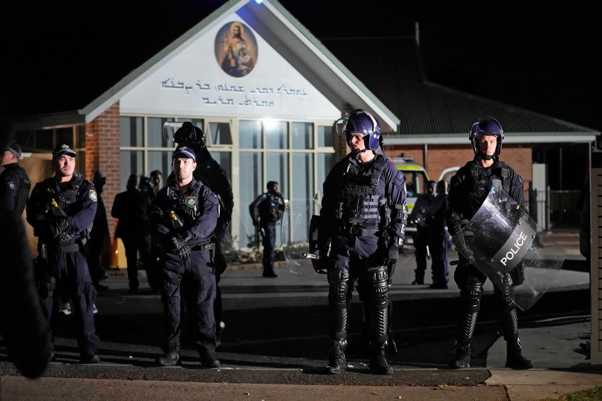 Security officers stand guard outside Orthodox Assyrian church in Sydney following the attack  (AP)