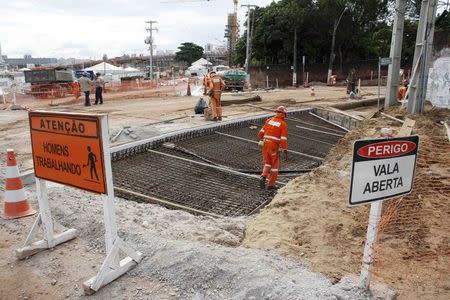 Workers work on areas of infrastructure near the construction site of the Arena das Dunas stadium, in Natal May 10, 2014. REUTERS/Nuno Guimaraes