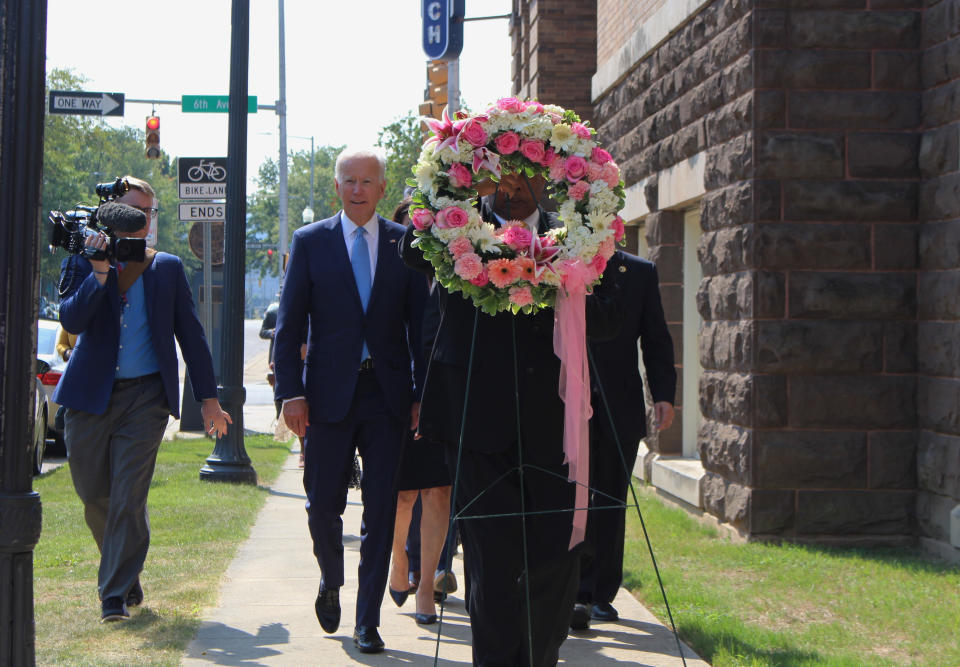 Former Vice President and presidential candidate Joe Biden, center left, joins Sen. Doug Jones and Birmingham Mayor Randall Woodfin at a wreath laying after a service at 16th Street Baptist Church in Birmingham, Ala., Sunday, Sept. 15, 2019. Visiting the black church bombed by the Ku Klux Klan in the civil rights era, Democratic presidential candidate Biden said Sunday the country hasn't "relegated racism and white supremacy to the pages of history" as he framed current tensions in the context of the movement's historic struggle for equality. (Ivana Hrynkiw/The Birmingham News via AP)