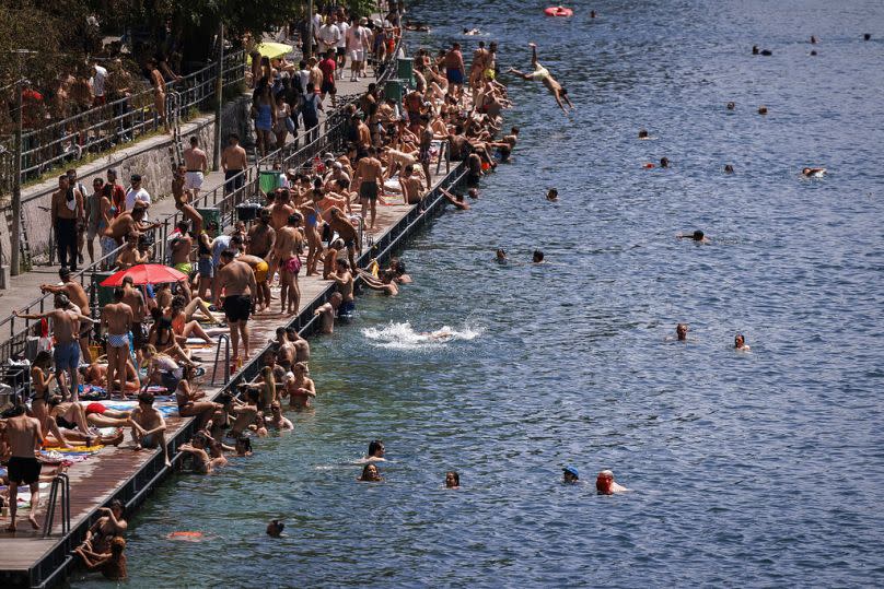 Dive in! People swim in the river Limmat at Letten, in Zurich, Switzerland